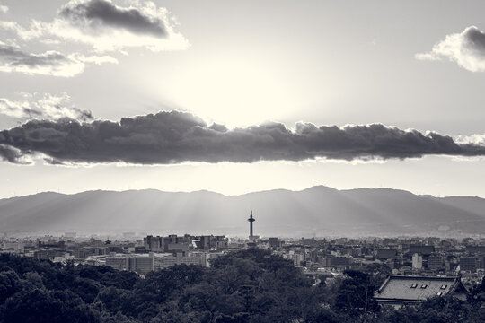 Sunset Over Kyoto Skyline with Rays Breaking Through Clouds, black and white