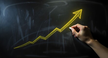Hand Drawing Upward Arrow on Blackboard Representing Growth and Success.