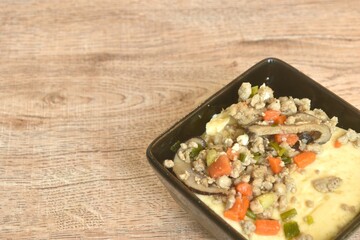 steamed egg with water topping slice black mushroom and chop pork topping carrot in cup on table 