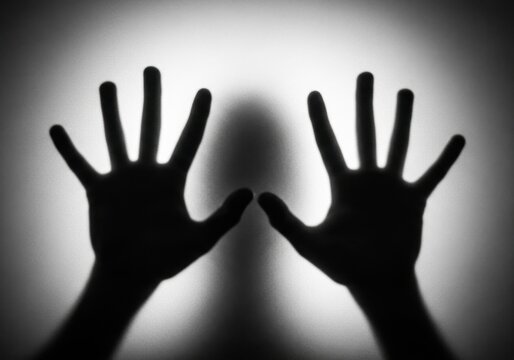 Silhouetted Hands on Frosted Glass