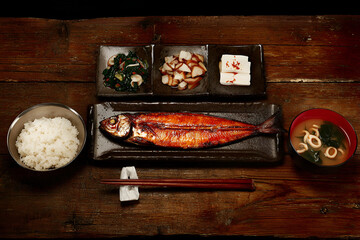 Traditional Japanese breakfast set with grilled fish, rice, and side dishes, showcasing vibrant
