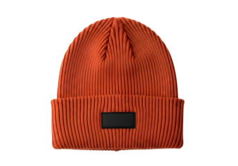 Orange knitted beanie hat with black patch isolated on transparent background