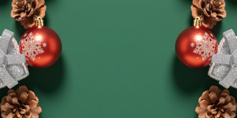 christmas ball and pine cone on green background,christmas decoration with gift box on a green...