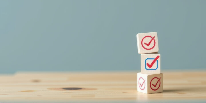 Stacked wooden blocks with check marks symbolize success and completion on wooden table against blue background. minimalist design conveys sense of achievement