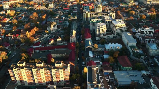 Aerial view of Alexandru cel Bun Street with mixed residential and modern buildings in central Chisinau at sunset