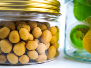 Crispy roasted peanuts packed in a clear glass jar with a golden lid, ready for healthy snacking and food storage solutions.