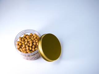 Delicious roasted peanuts in a clear container with a golden lid, perfect for snacks and culinary inspiration, ready for your next project.