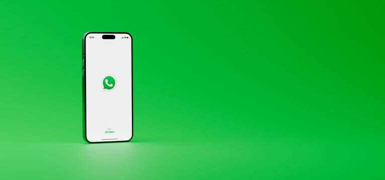 WhatsApp in mobile phone. Isolated iPhone on green background showing whats app opening screen. 3D render with copy space at right. Rosario, Argentina - November 5, 2025.