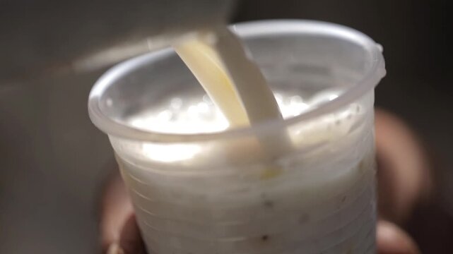 pouring Buttermilk, Raita into glass.