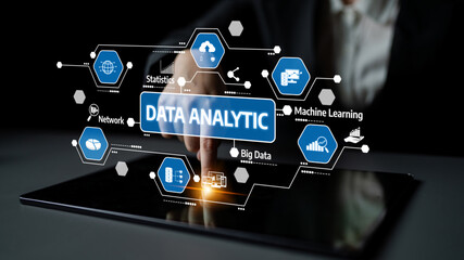This image portrays a person interacting with a touchscreen displaying data analytics concepts, including statistics and machine learning, highlighting a modern tech environment. Tessel