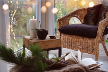 Cozy reading nook with comfortable furnishings and natural light. Background for leisure and relaxation.