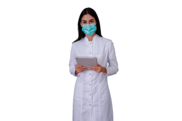 Woman doctor in medical uniform and facial mask, using a tablet, highlighting telehealth, technology in healthcare