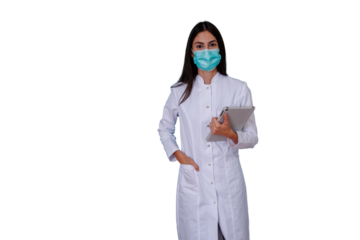 Young female doctor or medical professional wearing a surgical face mask and white lab coat, holding a digital tablet