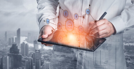 A business professional engaged in data analysis using a tablet showcases technology and innovation with connectivity icons and an urban backdrop. Tessel