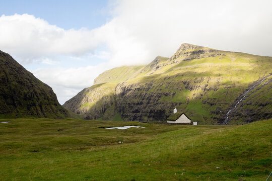 Saksun Church standing in a peaceful valley setting.