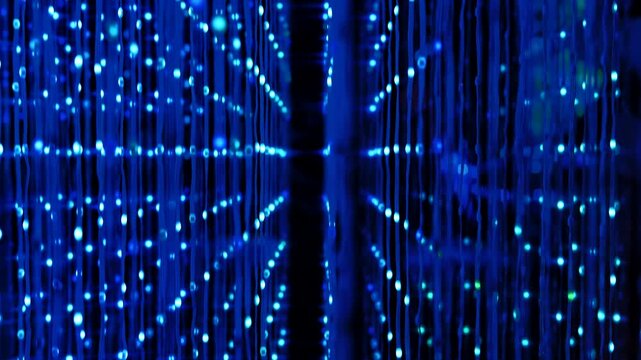 Data stream flowing through a network of blue light technology in an immersive art exhibition