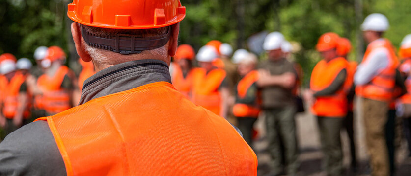Worker group wearing vest, safety. Builder man. Professional team and portrait of an engineer standing in a group, industrial factory. Working together