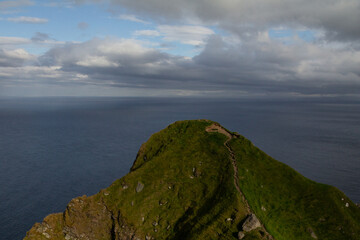 Steep mountain rising beside Kallur Lighthouse.