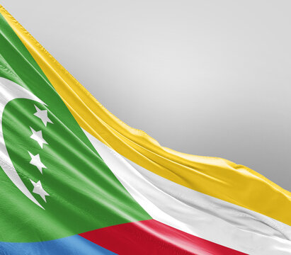 Comoros flag waving on grey background. Comoros national flag for independence day.