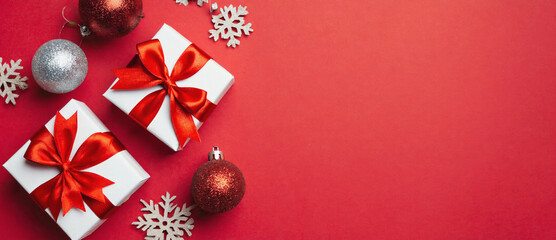 Festive Treasures: Gifts, ornaments, and snowflakes adorn a vibrant red backdrop, capturing the essence of the holidays.