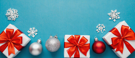 Festive Gift Array: An elegant arrangement of wrapped presents and shimmering ornaments on a radiant display setting the stage for seasonal festivities.