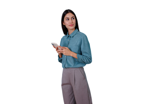 Young businesswoman holding a phone, texting or scrolling, looking aside with a pensive expression, considering data or messages