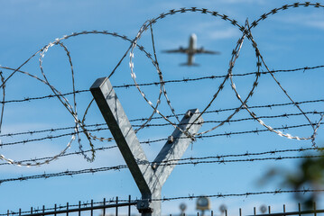 Hamburg, Deutschland, 20.9.2025 - Stacheldraht und Natodraht-Absperrung vor Flugzeug beim Start am...