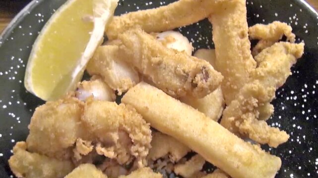 Dish with Fried calamari. just served at the table in an Andalusian restaurant.