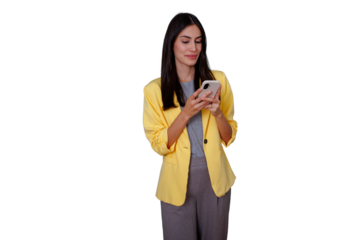 Businesswoman interacting with a digital device, standing confidently while typing on her cell phone, connecting to the internet