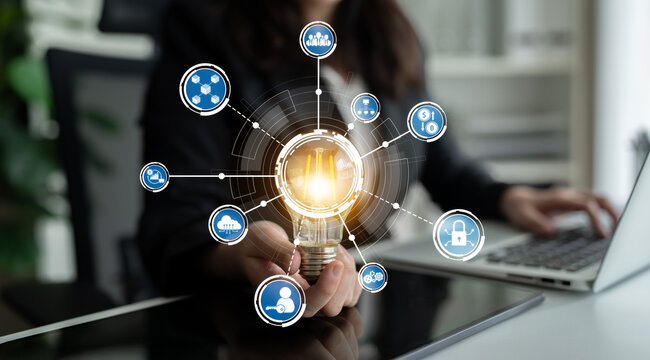 A creative light bulb symbolizes innovation and ideas, surrounded by digital icons representing technology and connectivity in a modern workplace environment. Crux