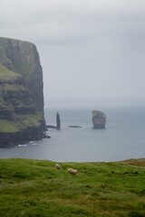 The iconic Risin og Kellingin sea stacks off Eysturoy island, Faroe Islands — a famous hiking and sightseeing spot on the Atlantic coast.