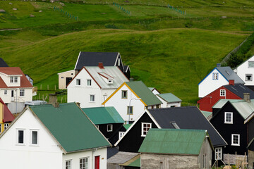 Traditional Nordic-style houses in Gjógv, Faroe Islands, showcasing colorful rooftops and coastal charm — ideal for travelers exploring hidden northern gems.
