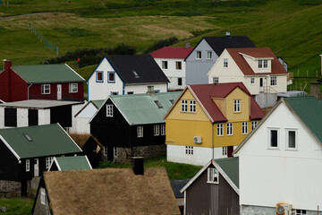 Traditional Nordic-style houses in Gjógv, Faroe Islands, showcasing colorful rooftops and coastal charm — ideal for travelers exploring hidden northern gems.