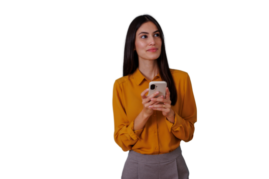 Young woman holding a mobile phone, looking cheerfully away while networking or communicating with a digital device