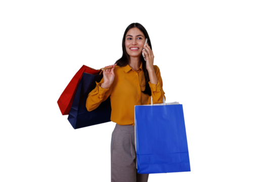 Young woman shopping, holding colorful bags and talking on mobile phone, smiling happy after purchases, transparent background