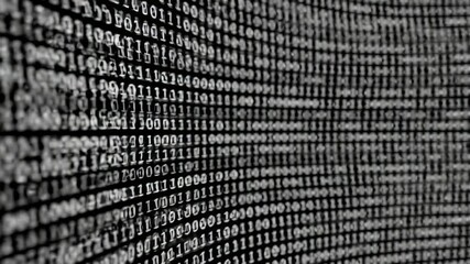 A close-up view presents a wall of binary code in shades of white against a black backdrop, creating a technological aesthetic - Powered by Adobe