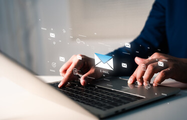 A businessman working on a laptop open email with sign reminder for unread emails for notification and taps on a new inbox email notification icon, newsletter. Technology digital online network