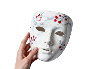 Hand holding a white theatrical mask with delicate floral designs isolated on transparent background