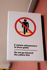 Warning sign at railway station prohibiting crossing of train tracks