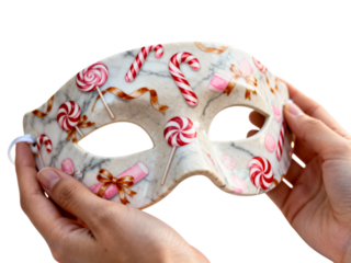Whimsical candy themed masquerade mask held by hands isolated on transparent background