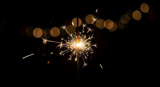 A single sparkler brightly in the dark, cinematic lighting with bokeh background