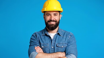 Cheerful construction worker with a beard, donning a bright yellow hard hat, stands confidently with arms crossed. Accomplished engineer exuding confidence in their professional attire