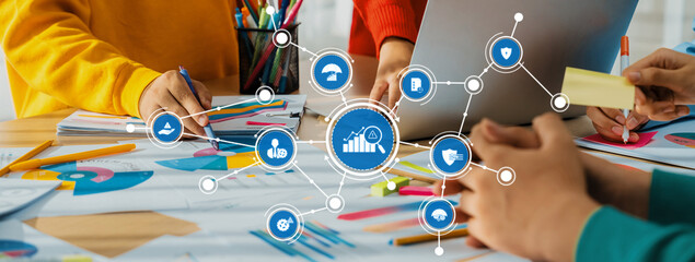 A vibrant workspace exemplifying collaboration with hands engaged in planning and analysis, featuring charts and colorful stationery for effective management strategies. Amity
