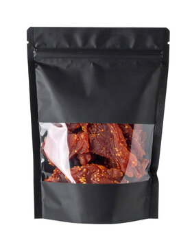 Beef jerky in a black stand up pouch, displaying savory dried meat snack with chili flakes through clear window