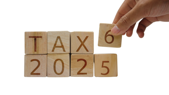 Tax Change 2025 to 2026. Wooden Blocks with Hand Adjusting Year.