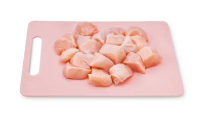 The fillet, sliced ​​into pieces, sits on a pink board made of eco-friendly plastic. white background.PNG