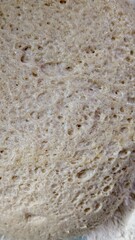 macro top-down close-up of an active, bubbly sourdough starter (leaven), showing the texture of fermentation and wild yeast.