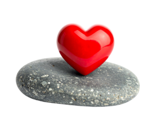 A glossy red heart rests atop a grey pebble against a contrasting dark background