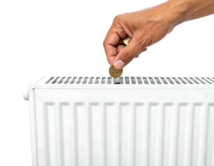 A hand dropping a coin into the top of a white, ridged heater with a black background