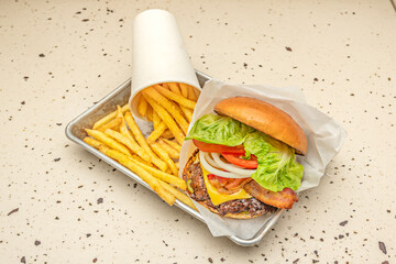 Beef burger with brie cheese, cranberry jam, and wild arugula on crystal bread